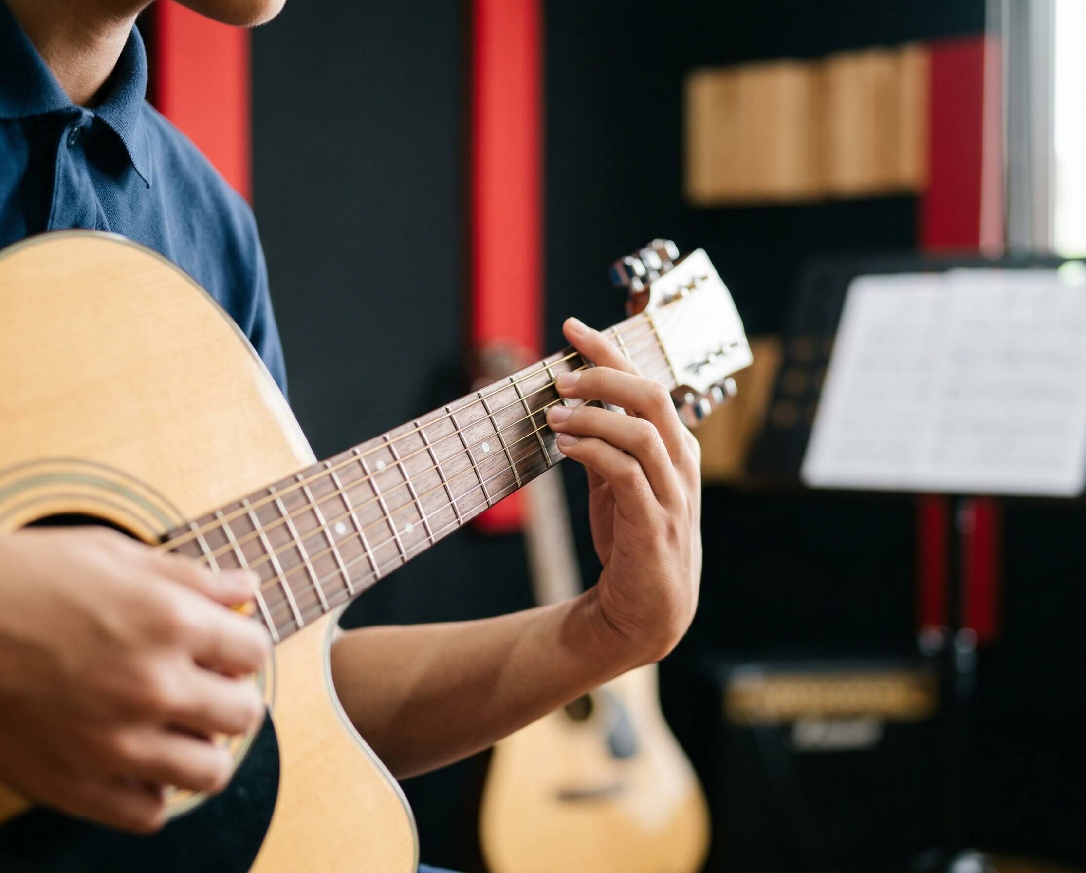 Student learning guitar chords